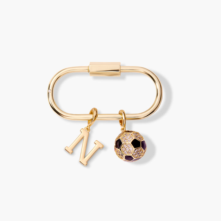 Oval carabiner-clasp key chain with a block-letter initial charm and a pavé crystal soccer ball charm with dark enamel panels.