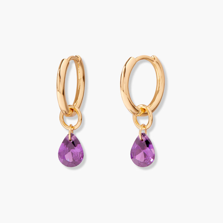 Hoop earrings with polished oval hoops, each suspending a faceted pear-shaped purple gemstone charm.