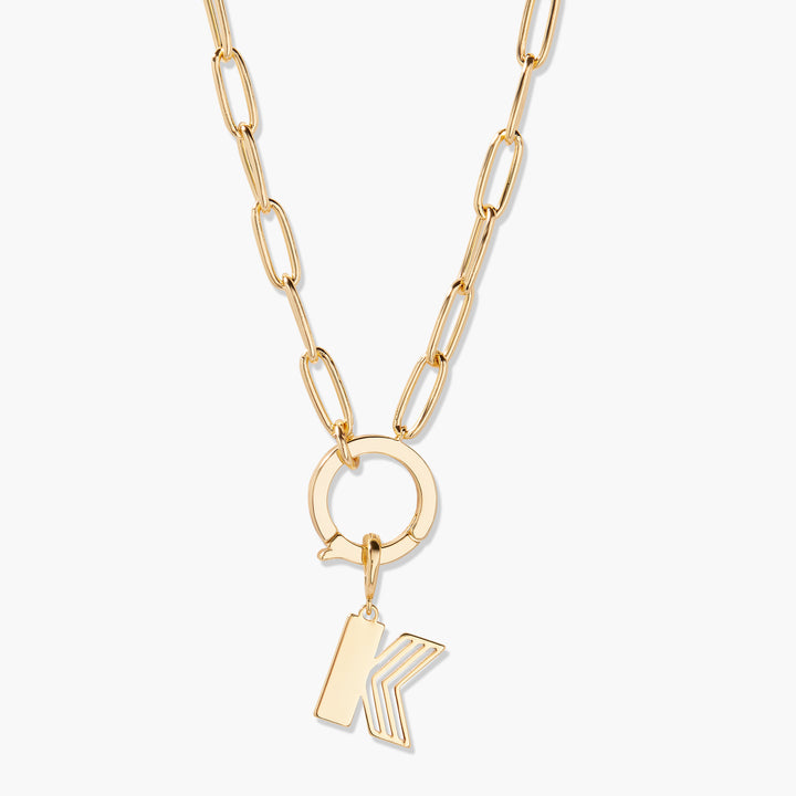 Gold necklace with a unique pendant on a white background
