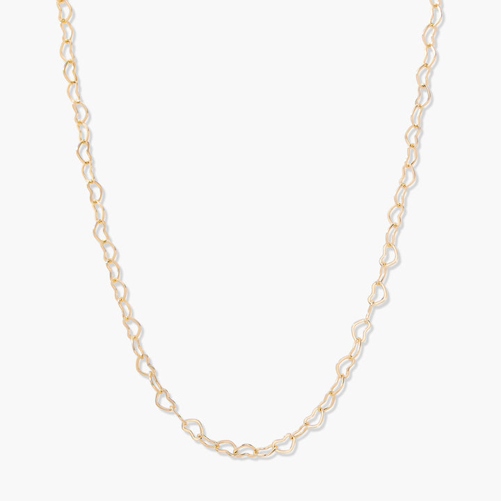 Seraphina Heart Necklace in gold-tone with open heart-shaped links forming a delicate chain necklace.