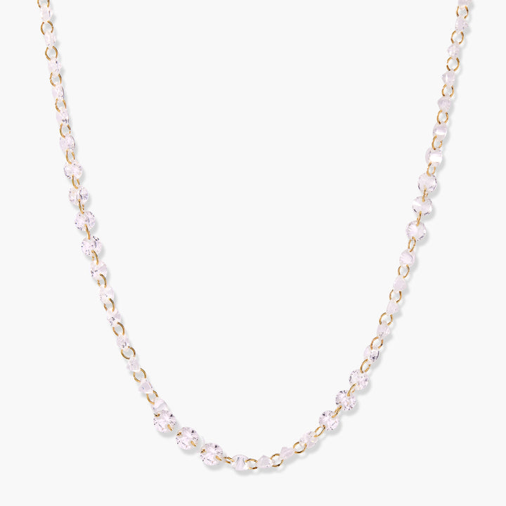 Gold-tone chain necklace with round clear cubic zirconia stones linked continuously along the full length.