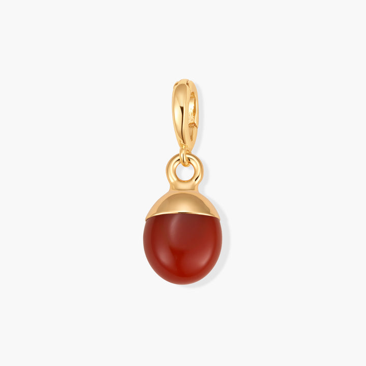 Perla Birthstone Charm with a deep red oval carnelian stone set in a gold-tone domed cap, attached to a gold-tone ring clasp.