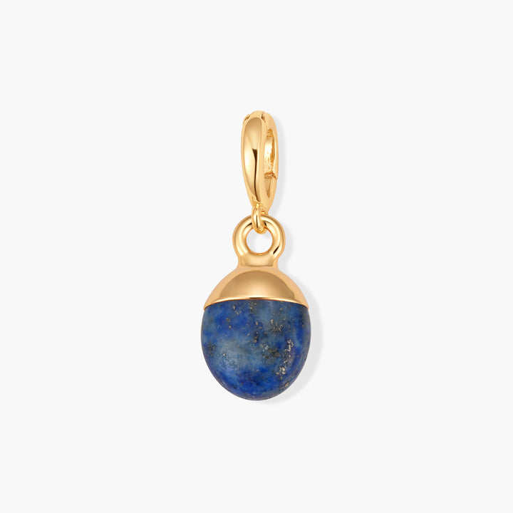 Perla Birthstone Charm with an oval lapis lazuli stone set in a domed cap, suspended from a ring clasp.