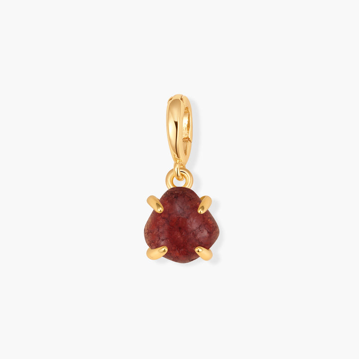 Mabel Birthstone Charm with a triangular deep red stone in a prong setting, suspended from a ring clasp.