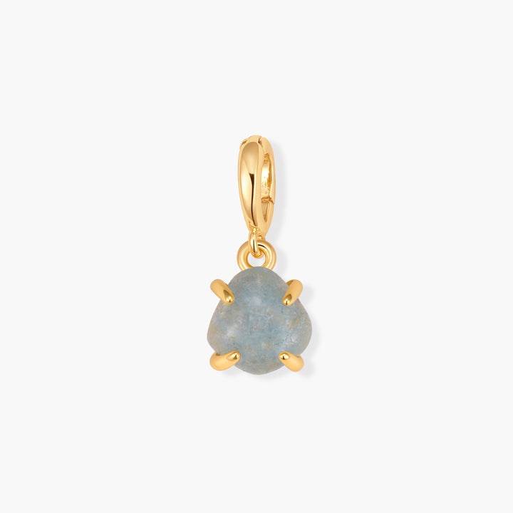 Mabel Birthstone Charm with a pale blue aquamarine stone in a prong setting, suspended from a ring clasp