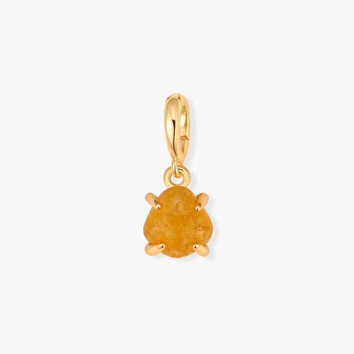 Mabel Birthstone Charm with a rounded yellow-orange cabochon stone held in a prong setting, suspended from a ring clasp.