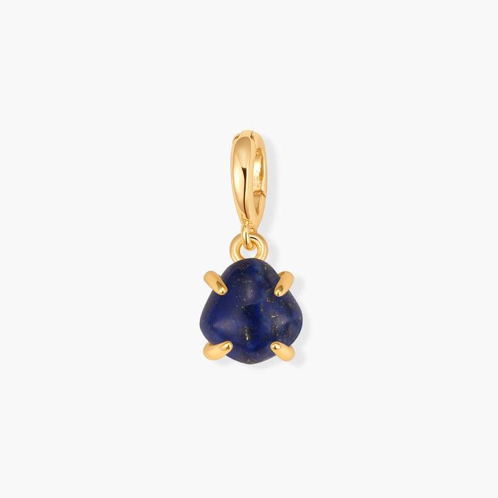 Mabel Birthstone Charm with a rounded triangular blue lapis lazuli stone in a prong setting, suspended from a ring clasp.