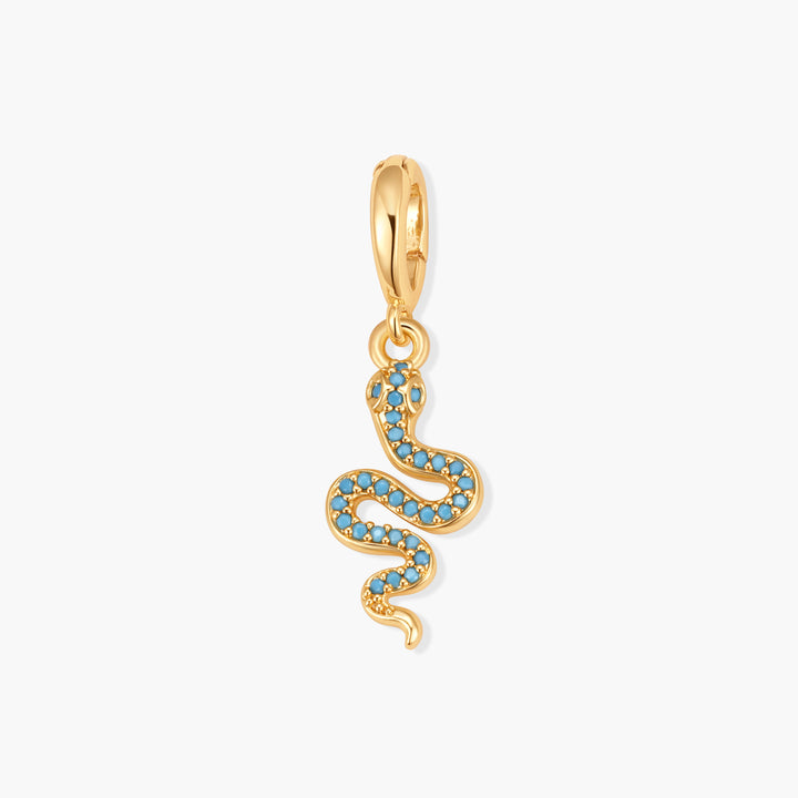 Gold-tone snake charm set with turquoise stones, suspended from a ring clasp.