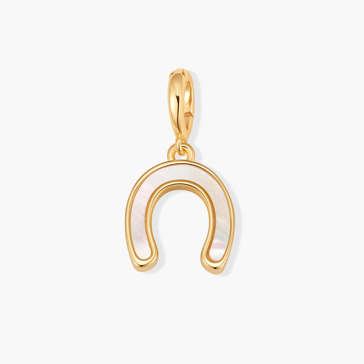 Gold-tone horseshoe charm inlaid with mother-of-pearl and a ring clasp at the top.
