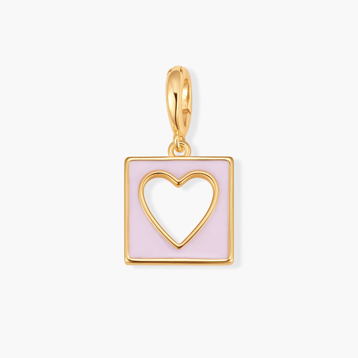 Gold-tone square charm with an open heart cutout on a pink enamel background, suspended from a ring clasp.