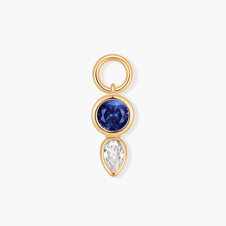 Vivienne Double Drop Birthstone Charm with a bezel-set round blue stone above a pear-shaped white stone and a ring clasp.