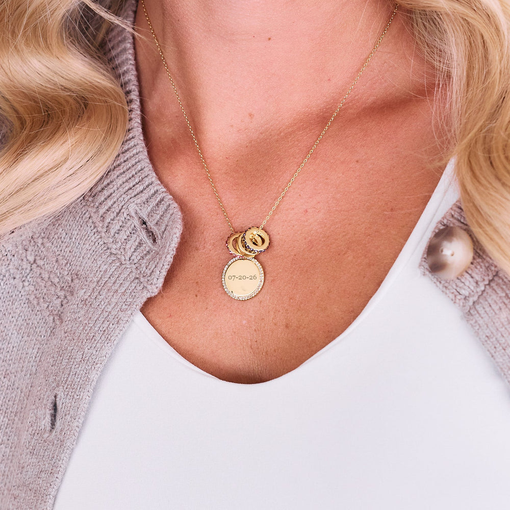  Anniversary Charm Necklace on a chain, with a pavé-edged round engraved disc pendant and stacked bead charms, one with colorful crystal rings on model.
