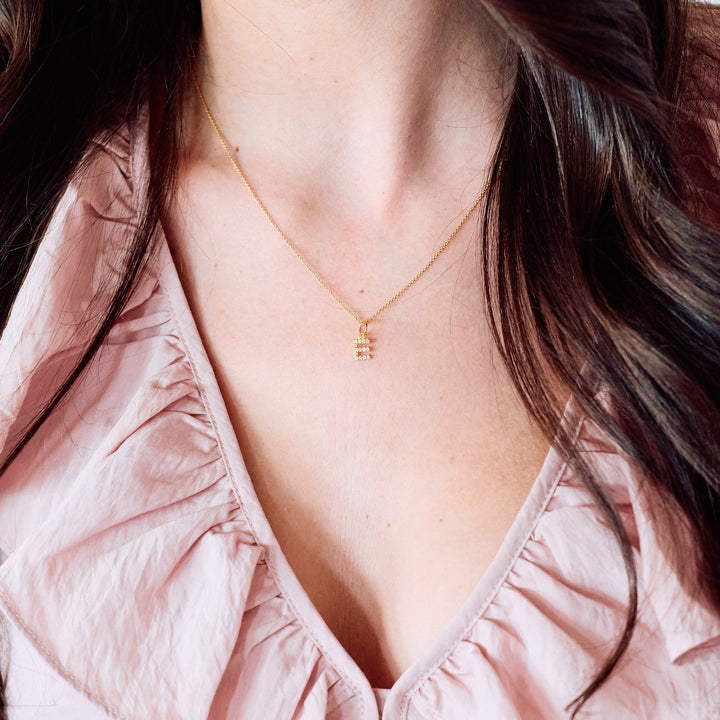 Blaire Diamond Initial Pendant necklace with a pavé-set letter charm, worn by a model.