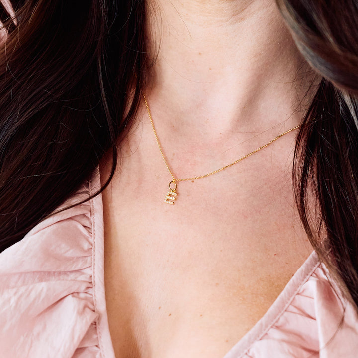 Blaire Diamond Initial Pendant necklace with a pavé-set letter charm, worn by a model.