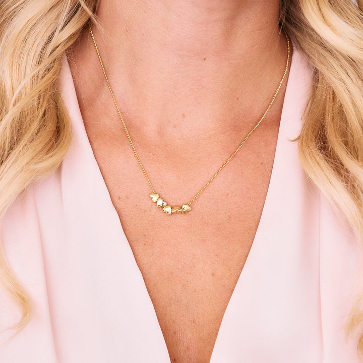 gold chain necklace with hearts on chain.