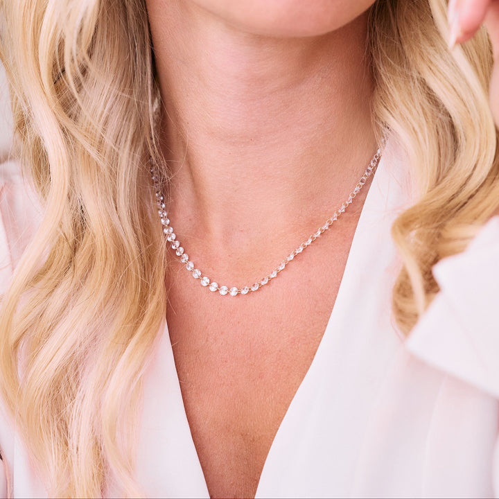 Chanel Floating Tennis Necklace with round cubic zirconia stones linked along a delicate chain, worn by a model.