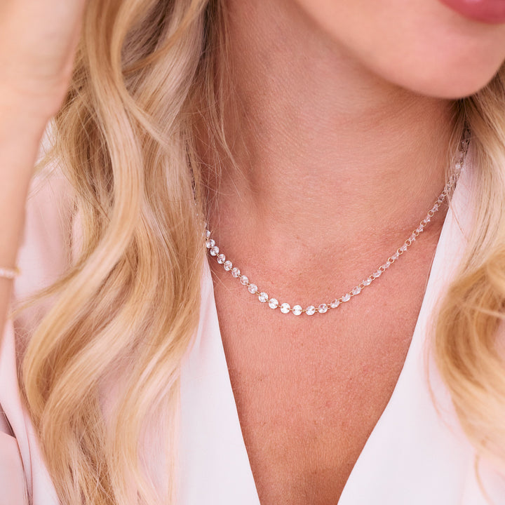 Chanel Floating Tennis Necklace with round crystal stations linked along a delicate chain, worn by a model.