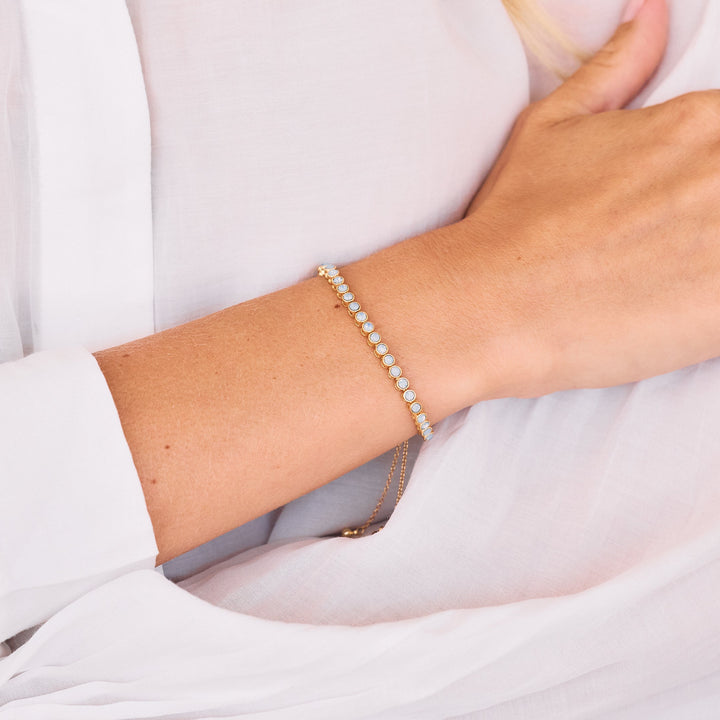 Gold bolo tennis bracelet with opal stones on women&
