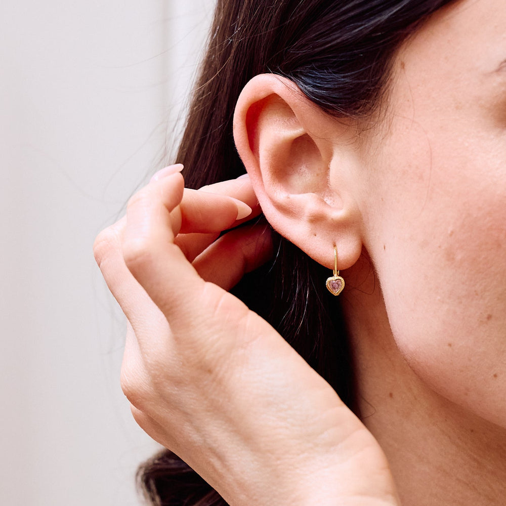  Lia Heart Birthstone leverback earrings with milgrain bezel heart charm on models ear.